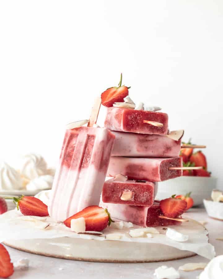Eton Mess Ice Lolly with Coconut Cream on  plate with strawberry, coconuts and meringues 