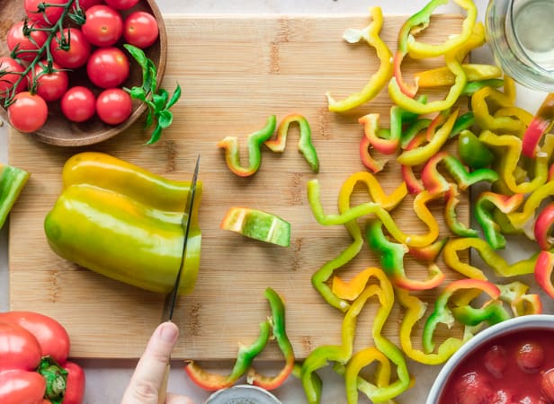 Cutting peppers on a chopping board