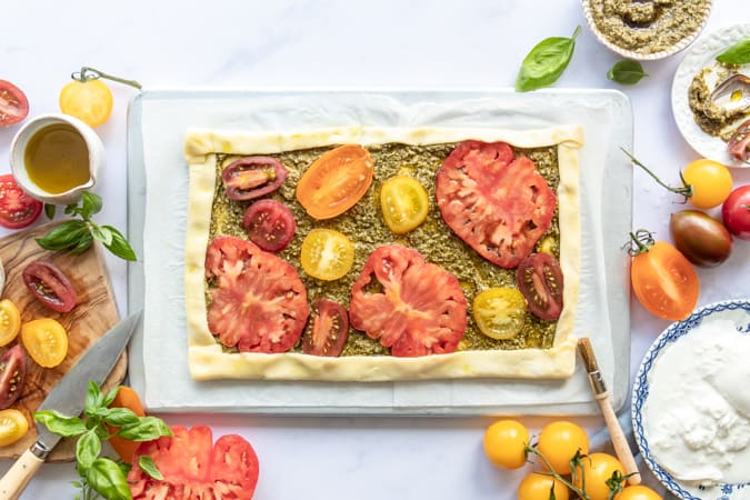 Folding the pastry side of the Tomato Tart With Pesto And Burrata