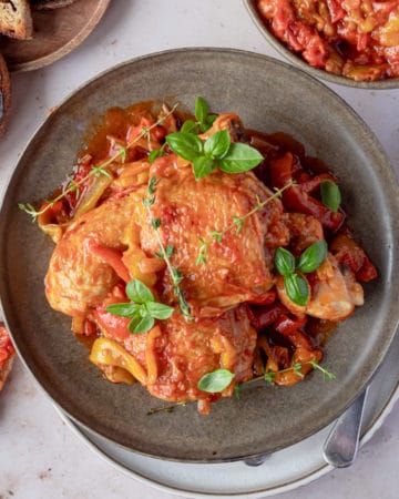 one-pot italian chicken on a plate with a slice of toasted bread