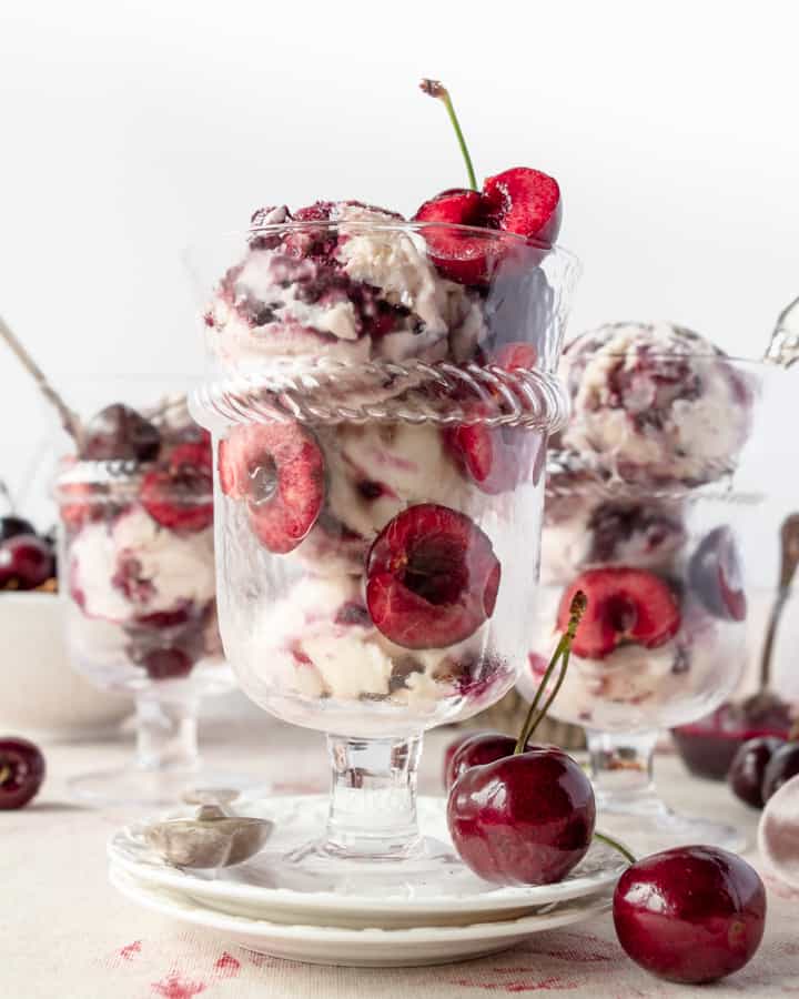 Homemade cherry ice cream with halved cherries on glasses 