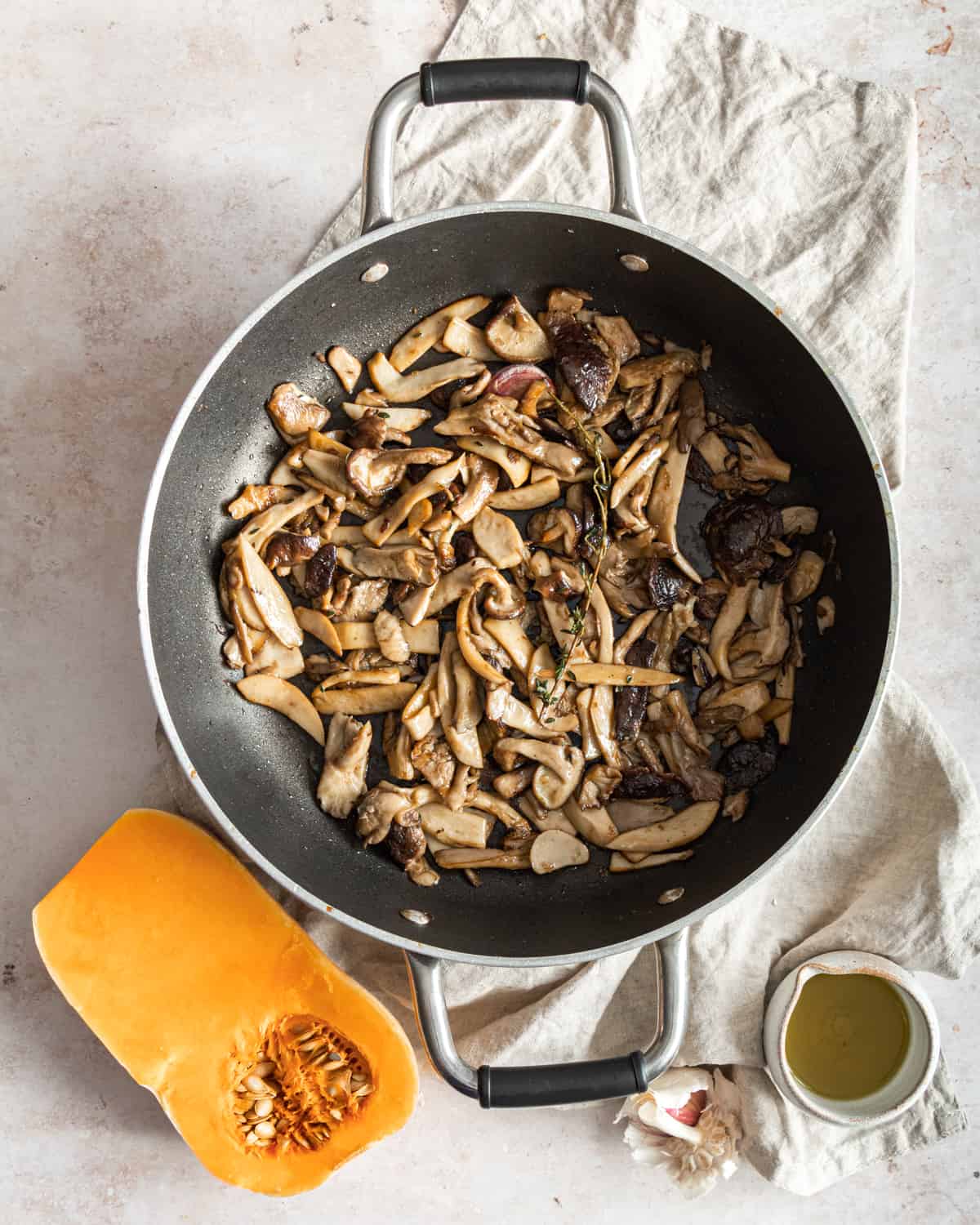 pan fried mushrooms with thyme on a cloth 