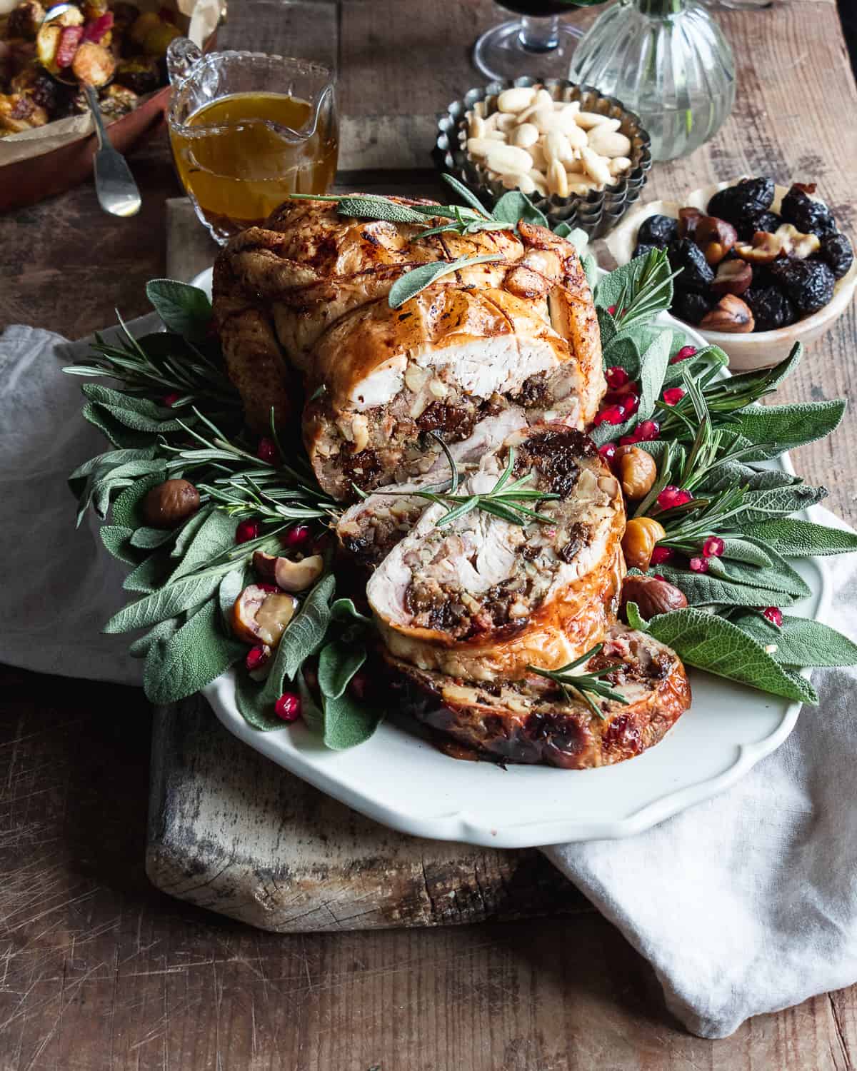 roasted chicken with bread stuffing on a plate with herbs 
