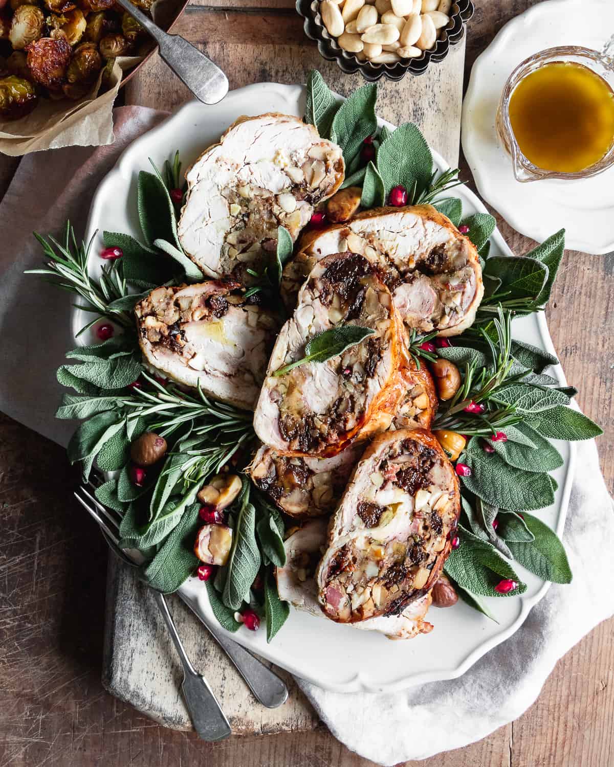 slices of stuffed chicken roast recipe on a plate with herbs 