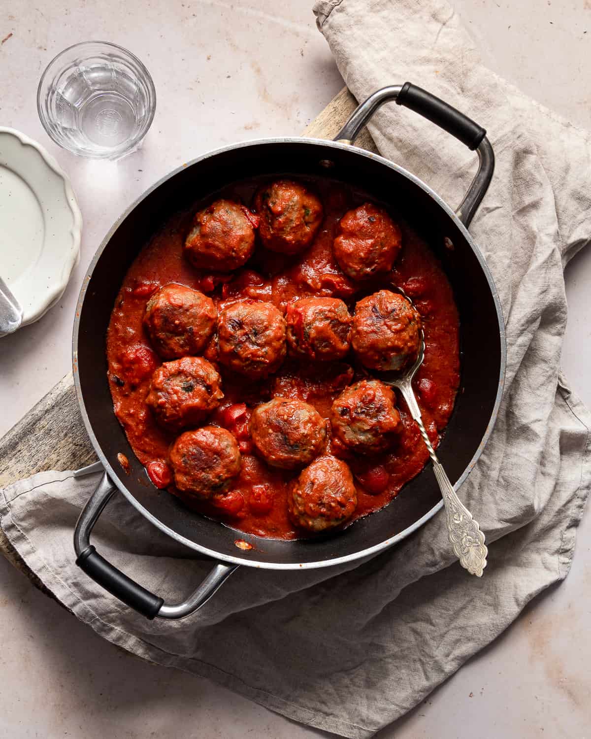 Cheese stuffed meatballs recipe with mortadella on a pan with a spoon