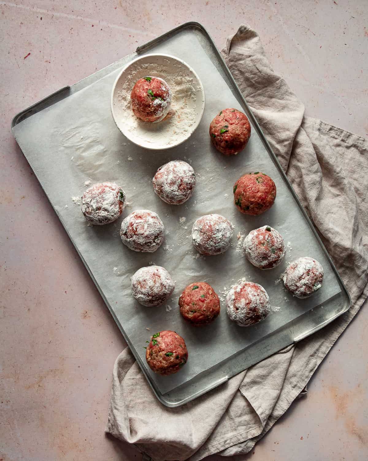 Coated meatballs with the flour on a tray 