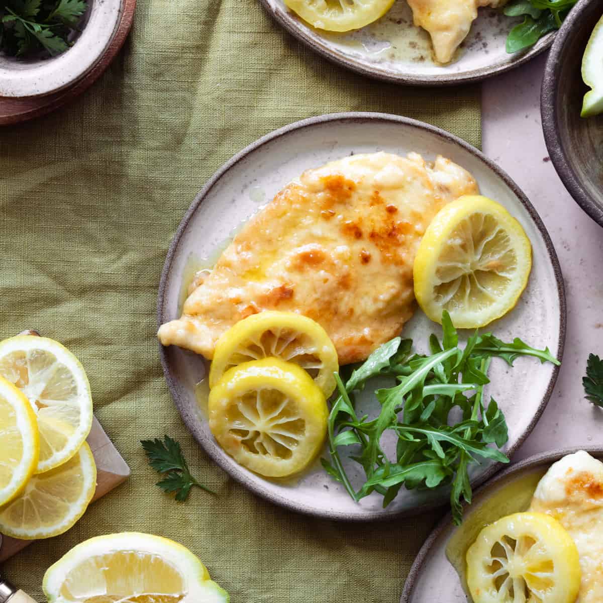 Chicken with lemons and arugula on a plate