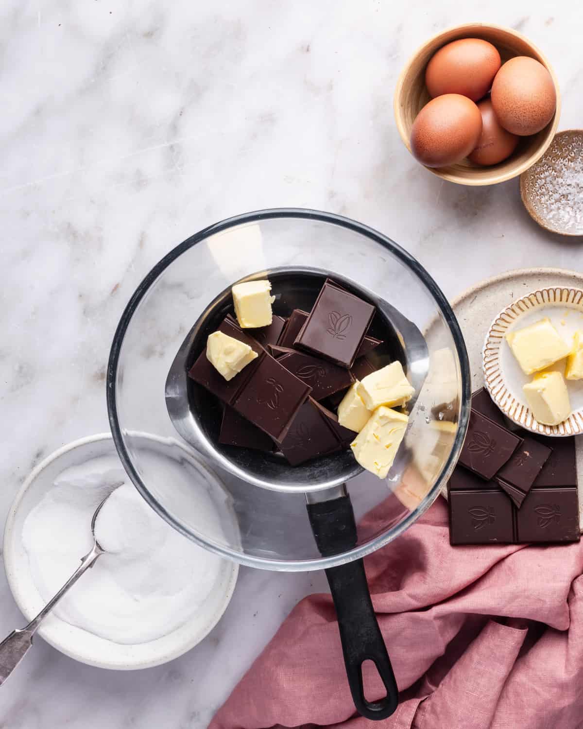 Step bain-marie step recipe with chocolate and butter into a bowl o top of a pan. 