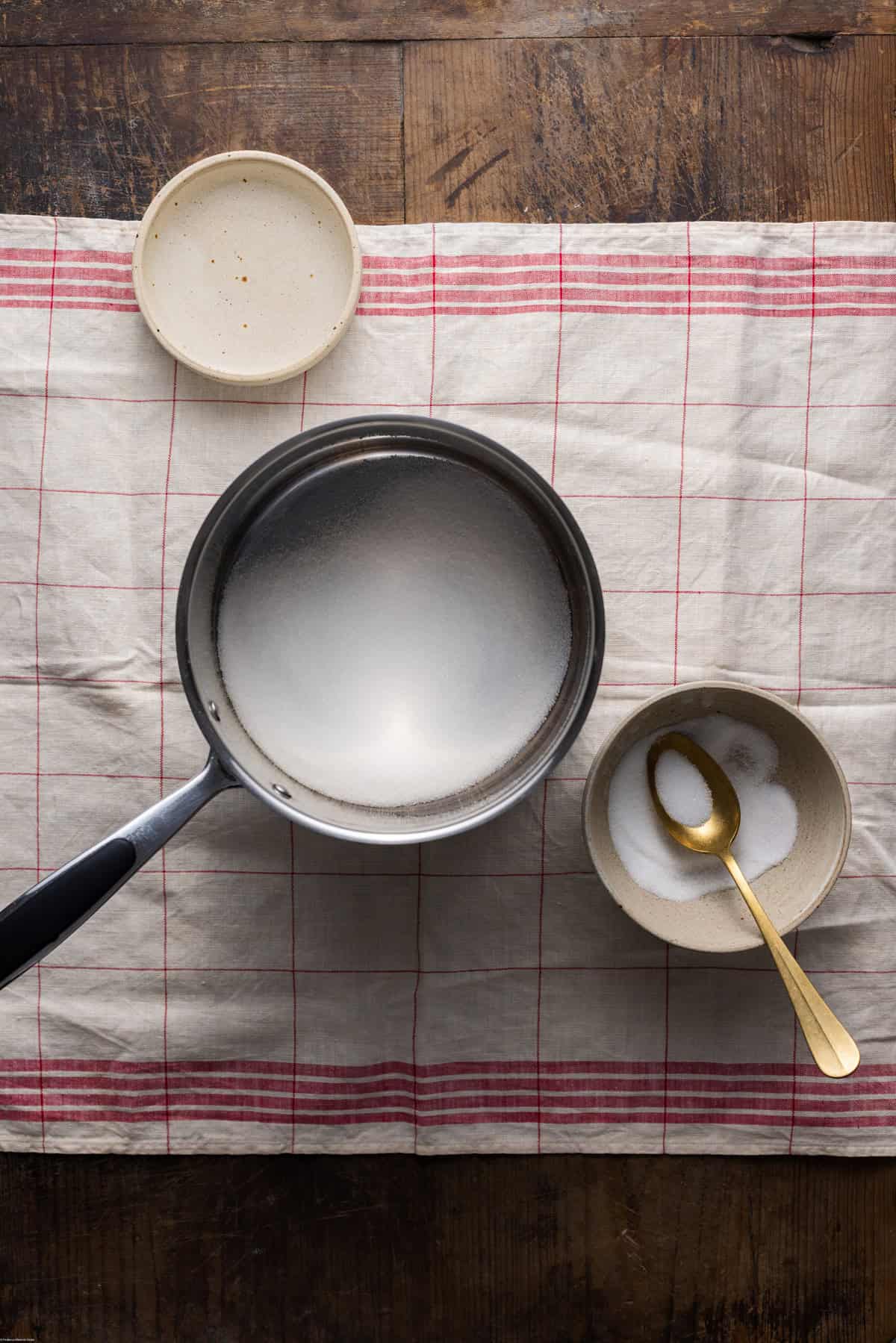 A caster sugar placed on a medium saucepan ready to make the syrup.