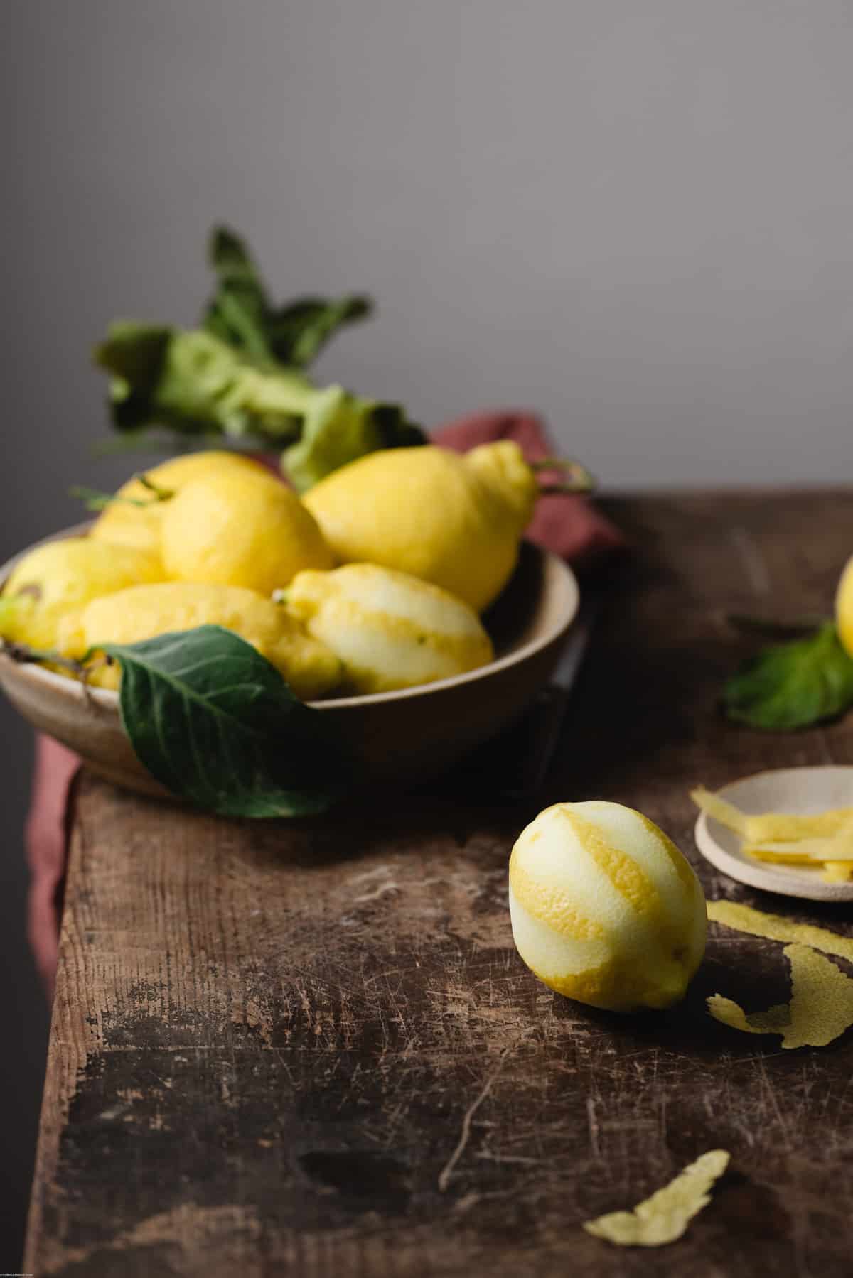 Lemon with peel around on top a kitchen table.