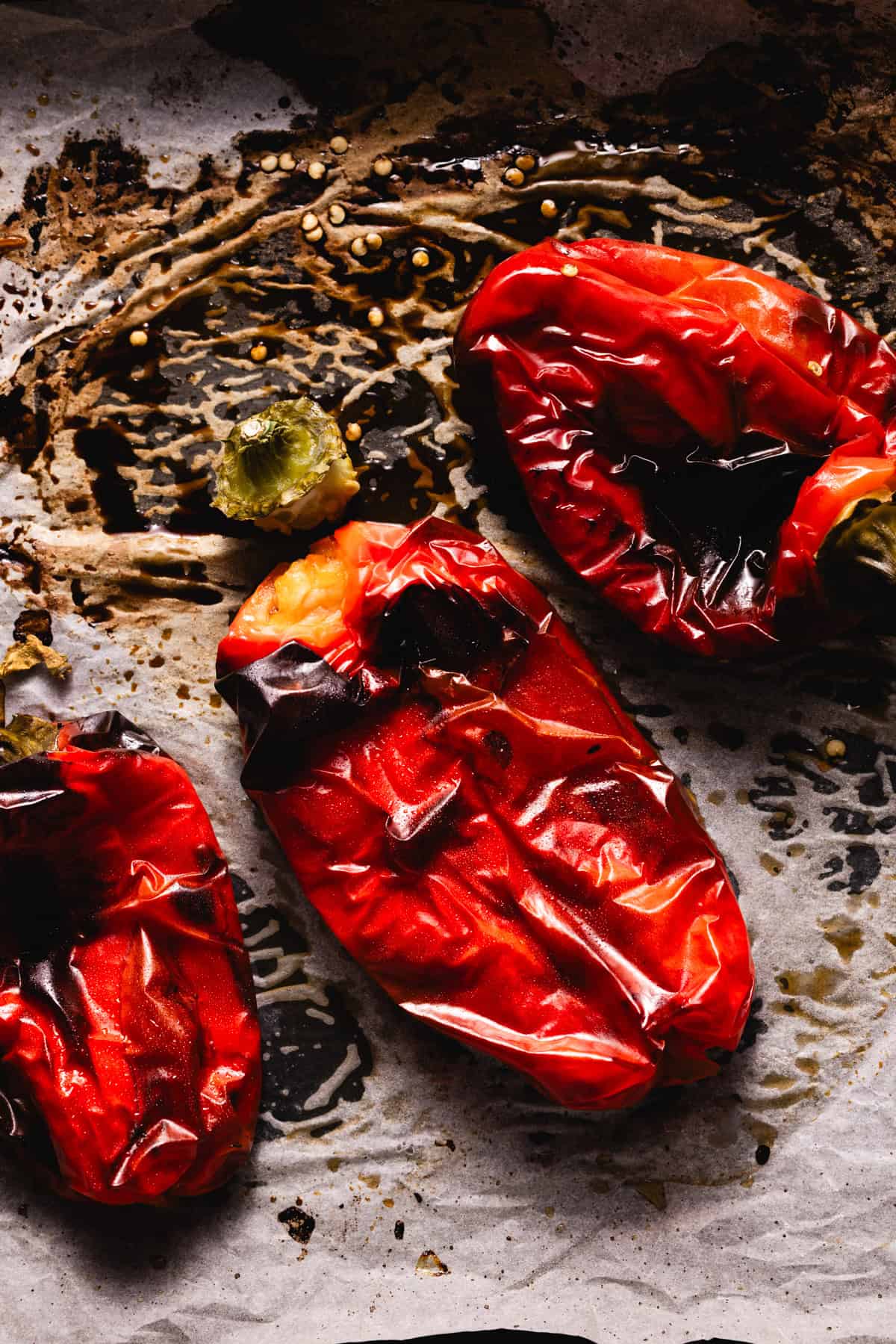Roasted red peppers on a kitchen paper ready to be peeled.