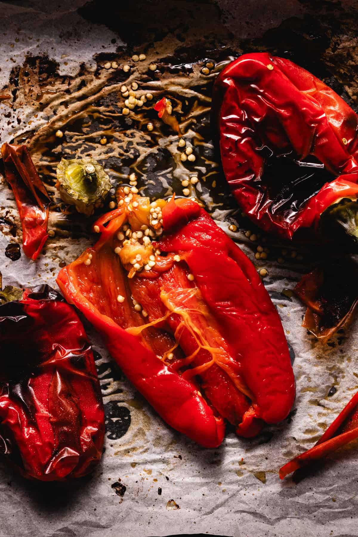 Red pepper sliced into two with seeds inside, ready to be sliced into long strips.