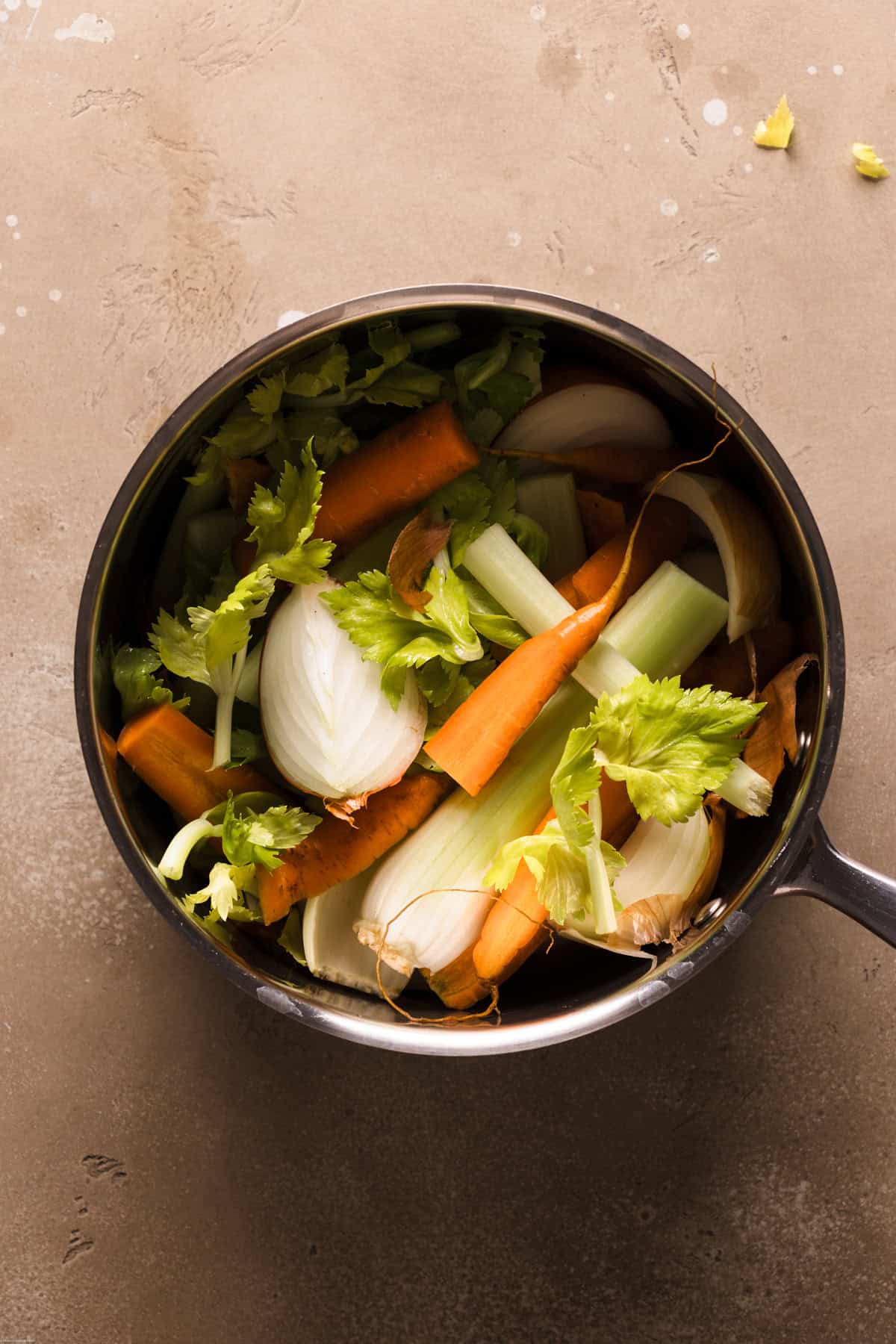 a process step of a broth pot filled with carrots, onion and celery all made into chunk
