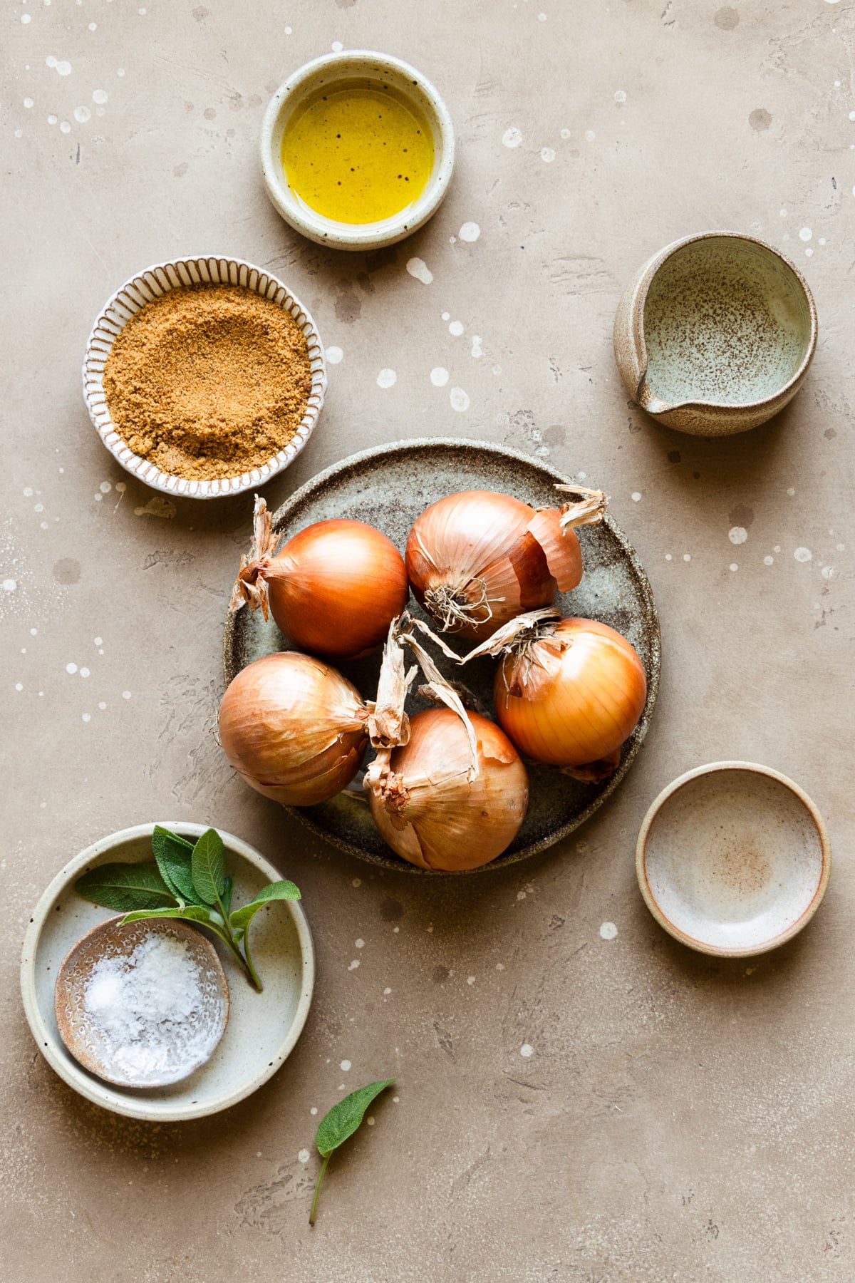 ingredients to make the caramelized onions on a brown backdrop